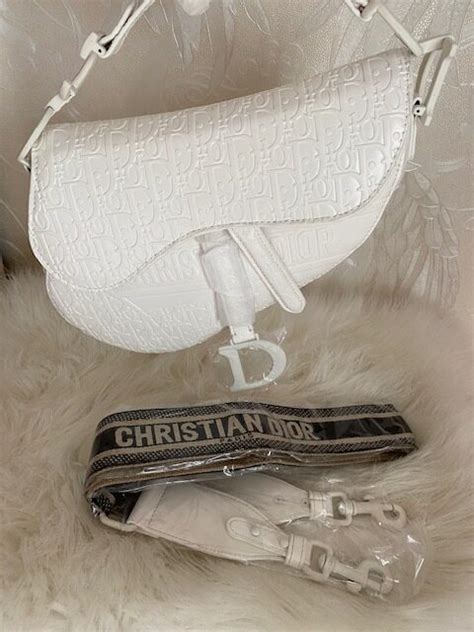 white dior saddle bag with gold hardware